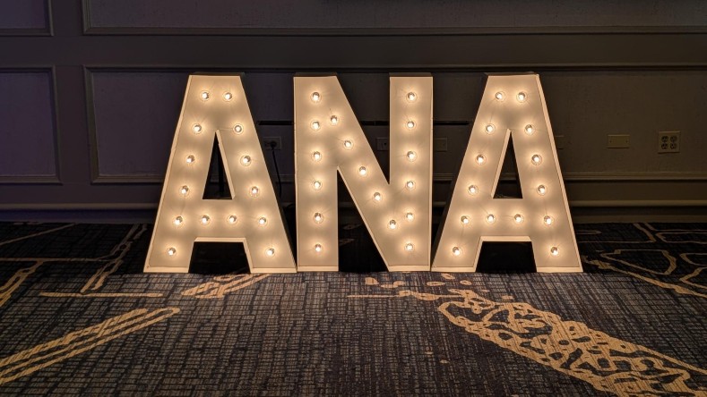 An ANA sign sits in a conference room.
