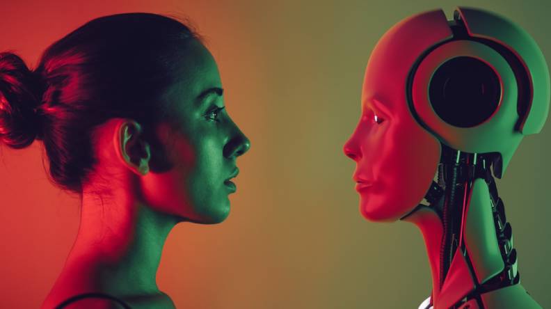 A woman and a robot stare each other down.