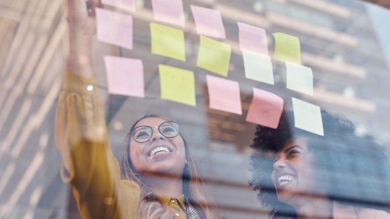 Colleagues work from sticky notes.