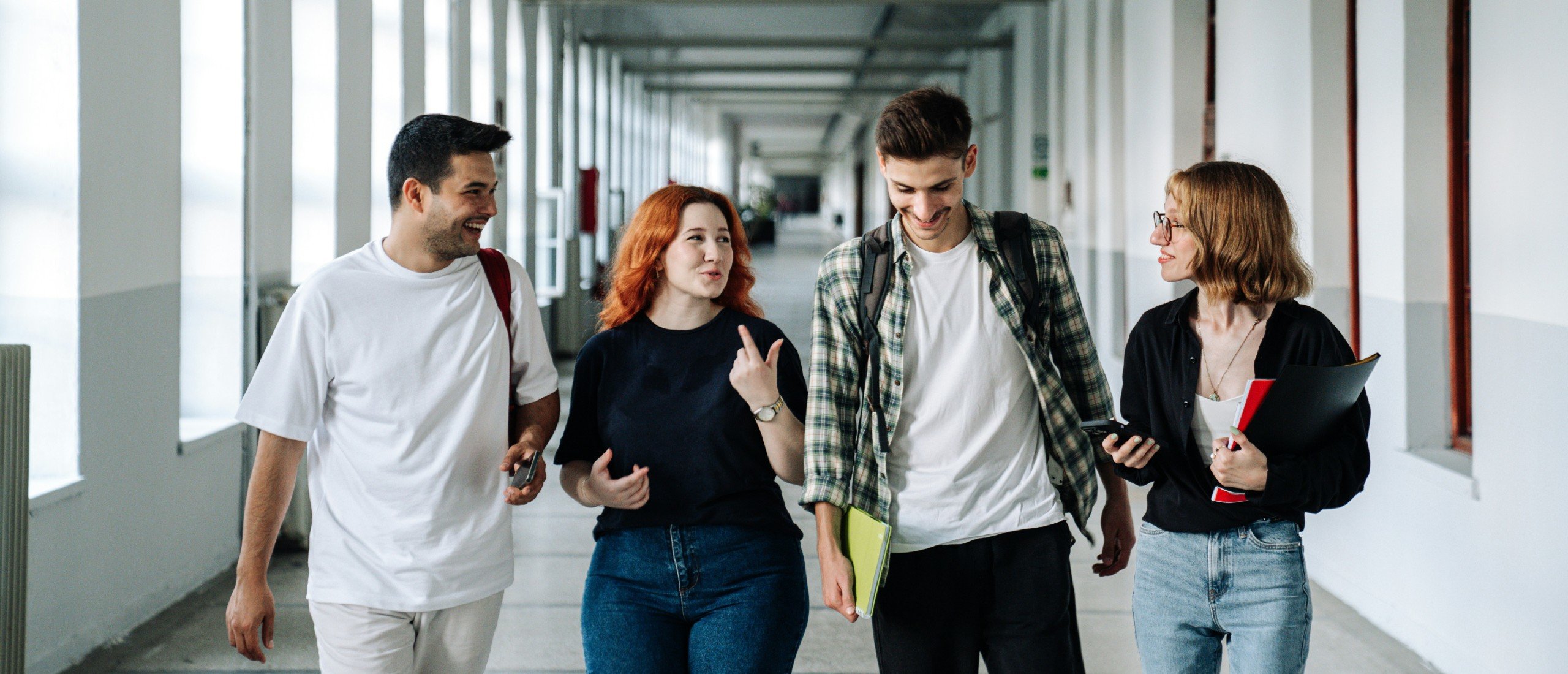 Students walk down a university hallway