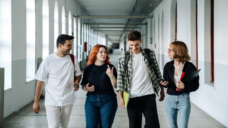 Students walk down a university hallway
