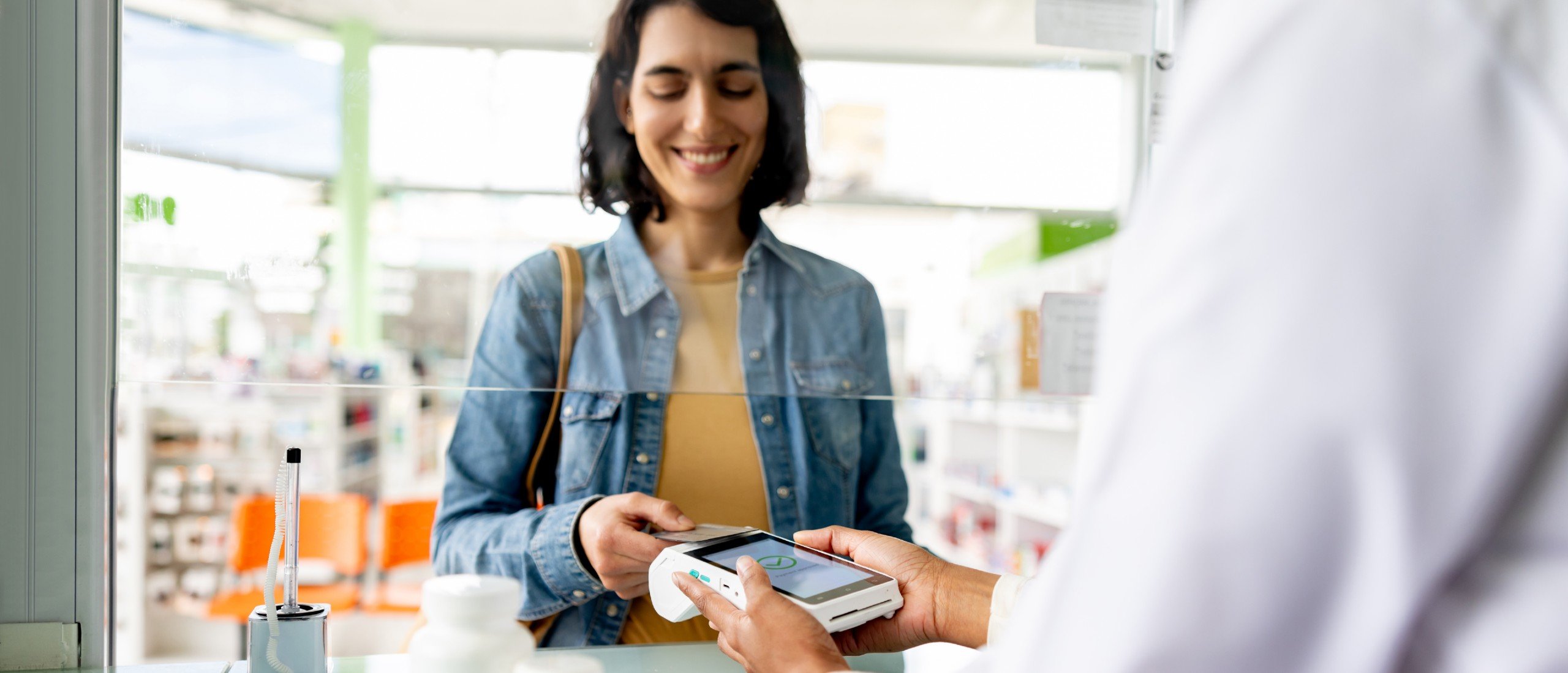 A woman pays for her prescriptions.