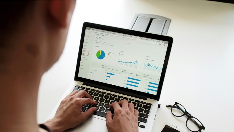 A laptop shows performance analytics.