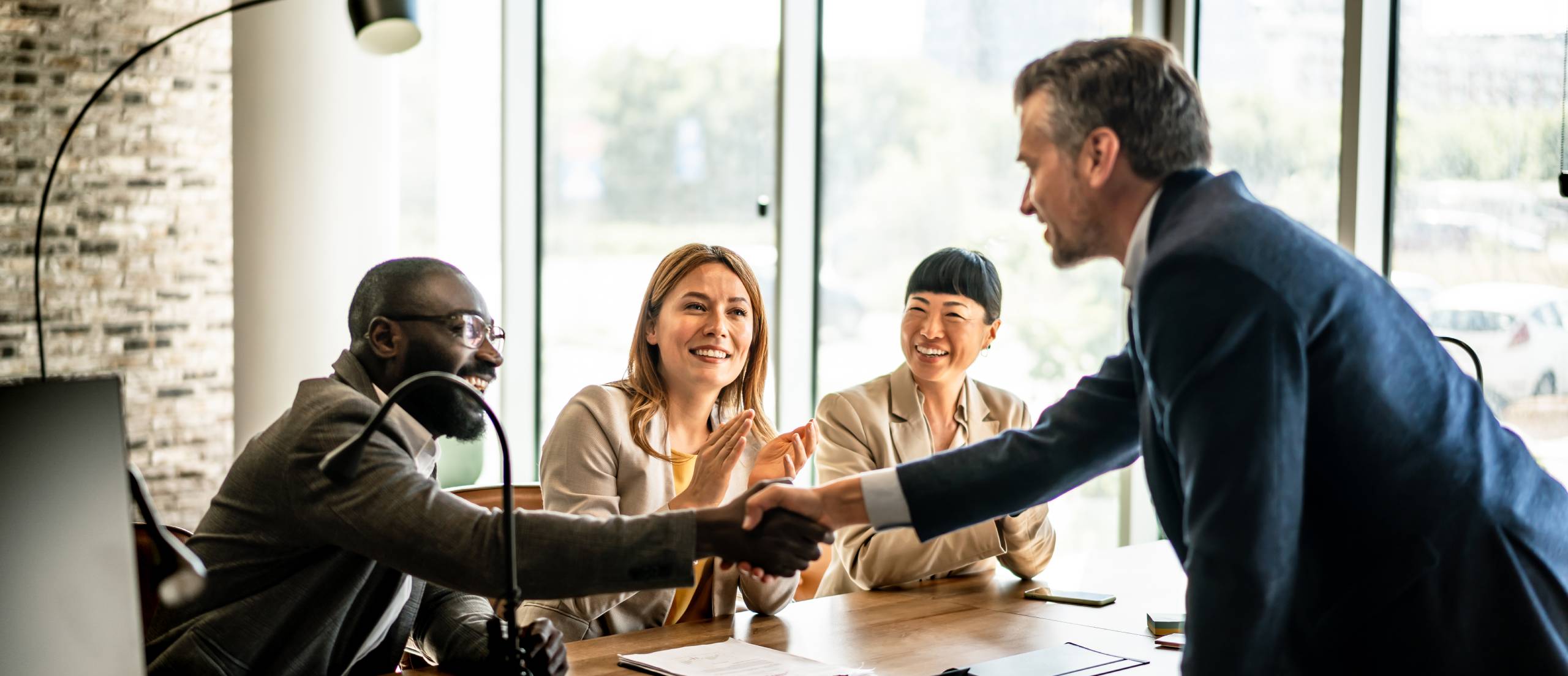 A man accepts congratulations after presenting insights.