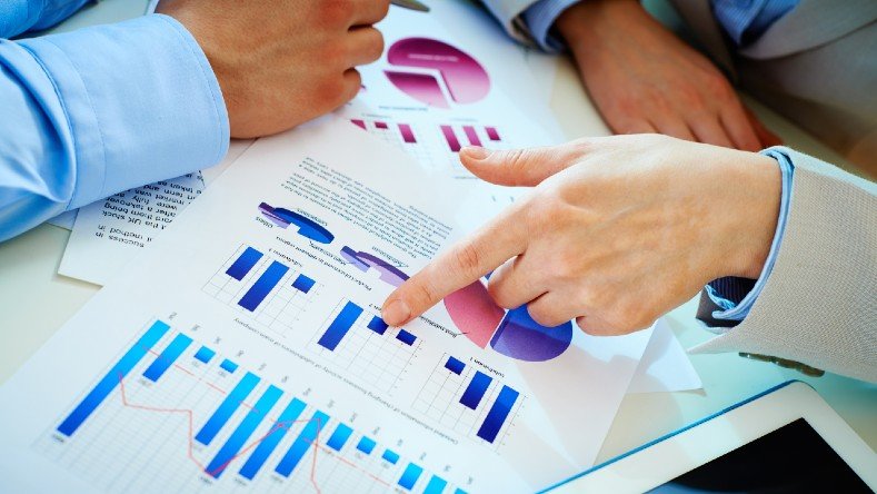 Business people go over research and graphs.