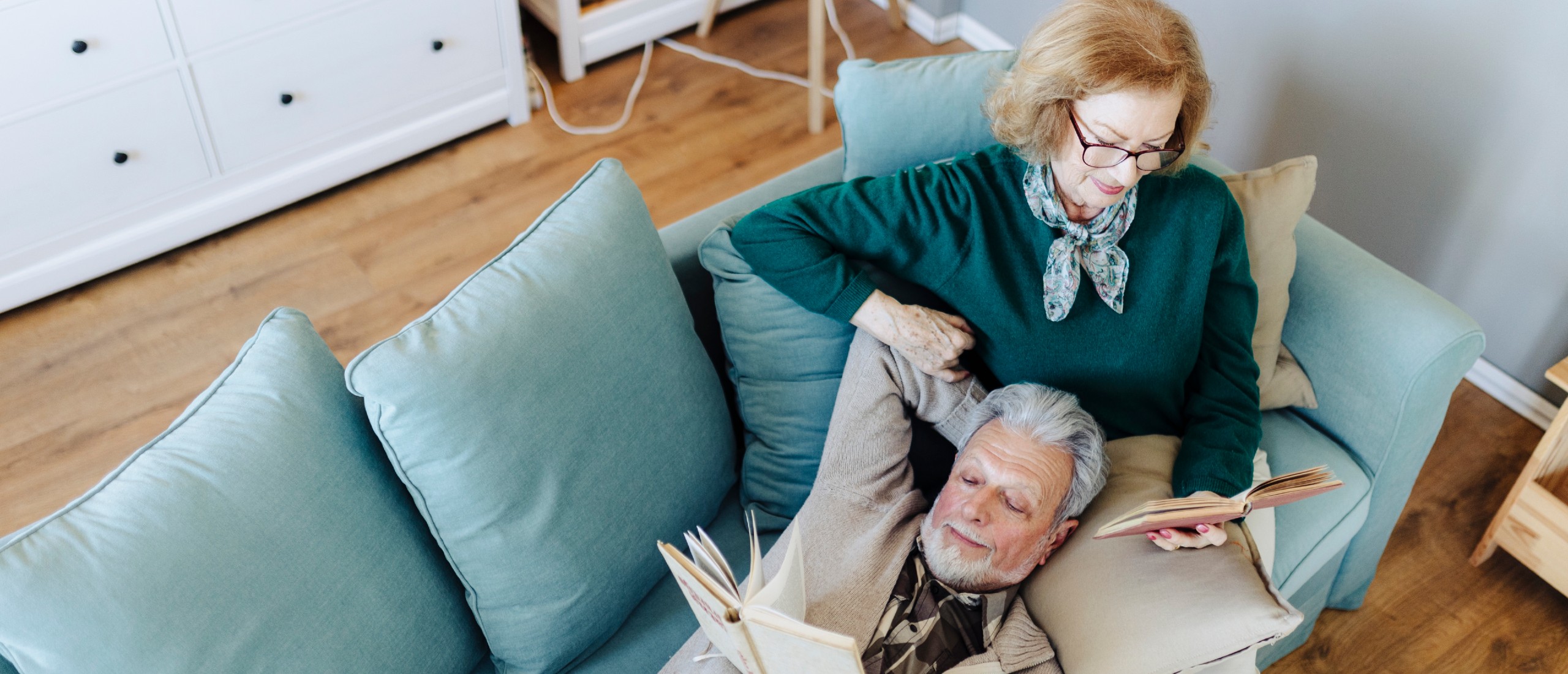 A senior couple relaxes on the couch