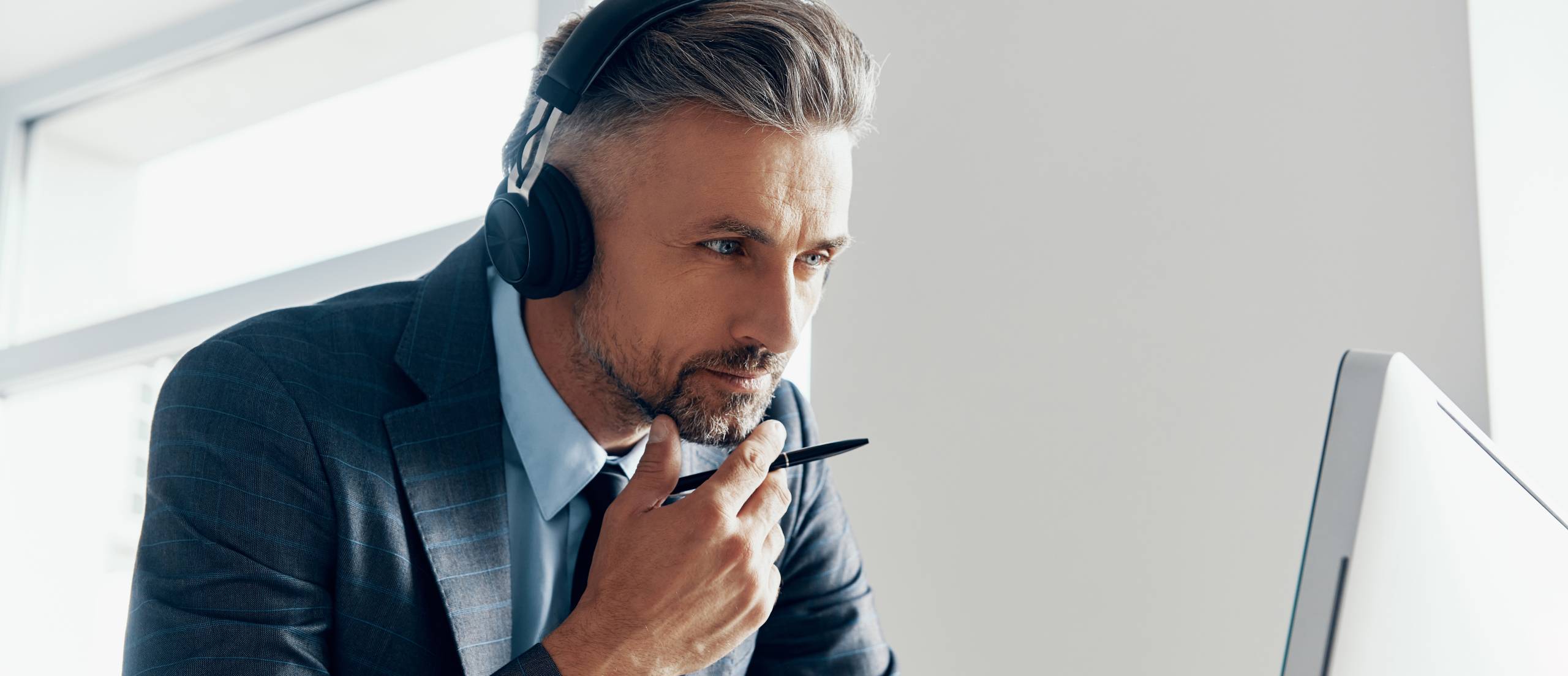A businessman watches a webinar.